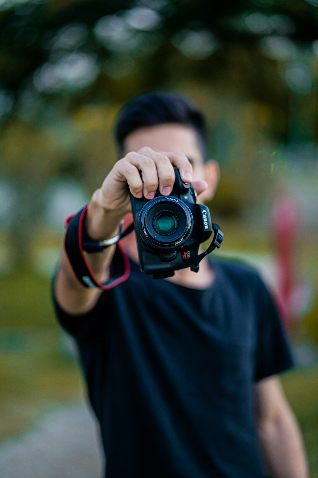 Documentary photographer holding a camera outdoors