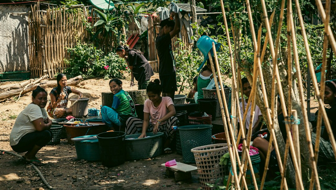 Small group of people gathered outdoors in a local community