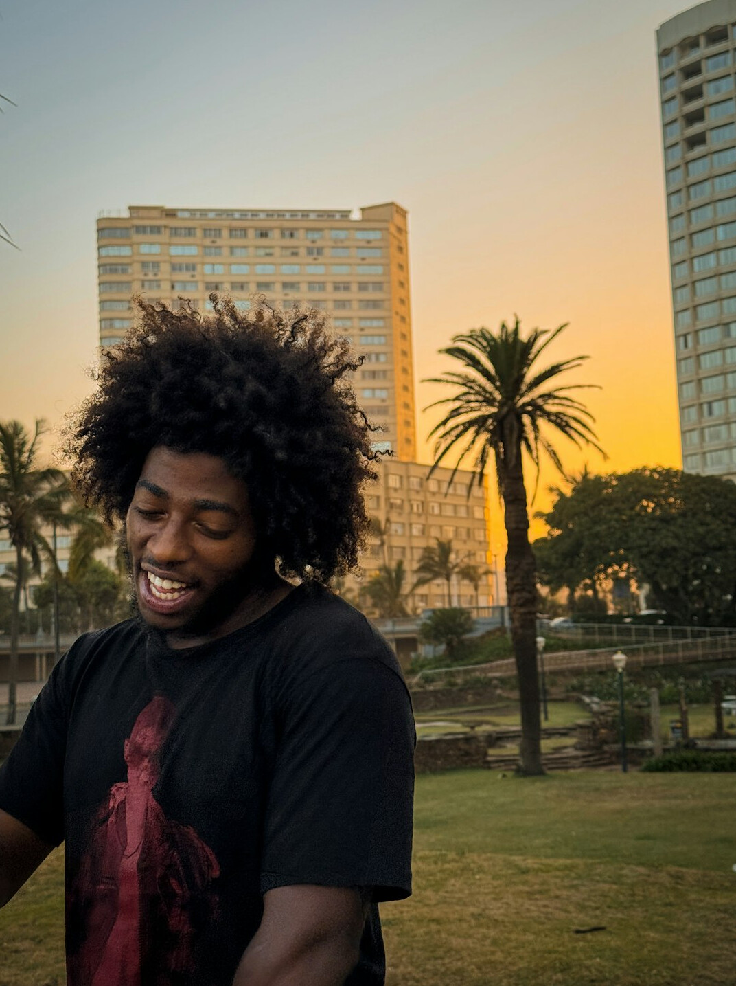 young man smiling in park